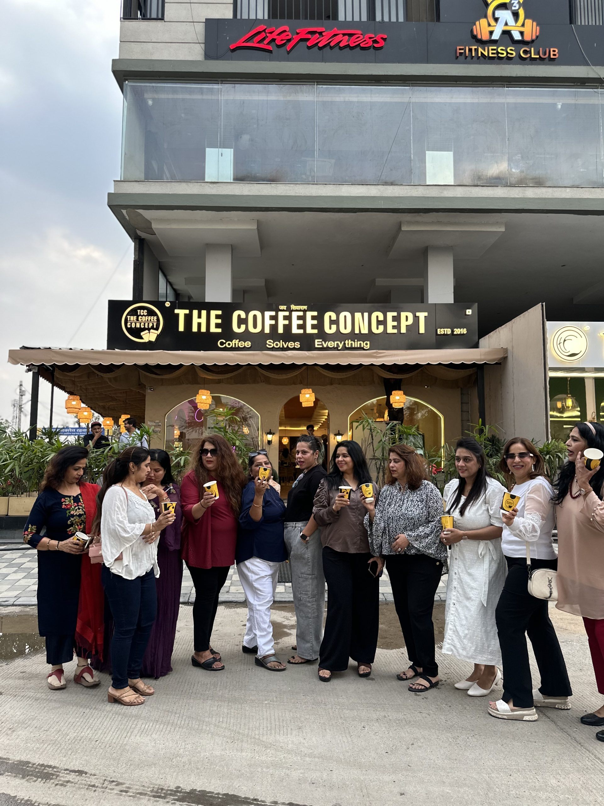 A crowd celebrating a TCC café opening