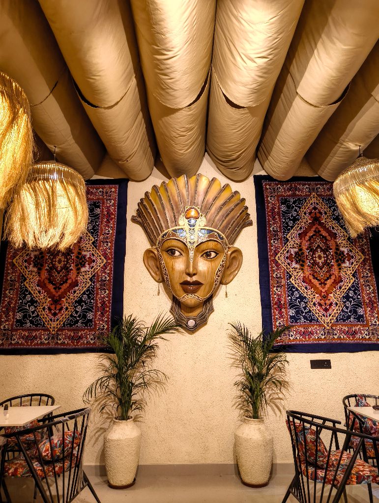 Inside The Coffee Concept — carved wall art and rugs