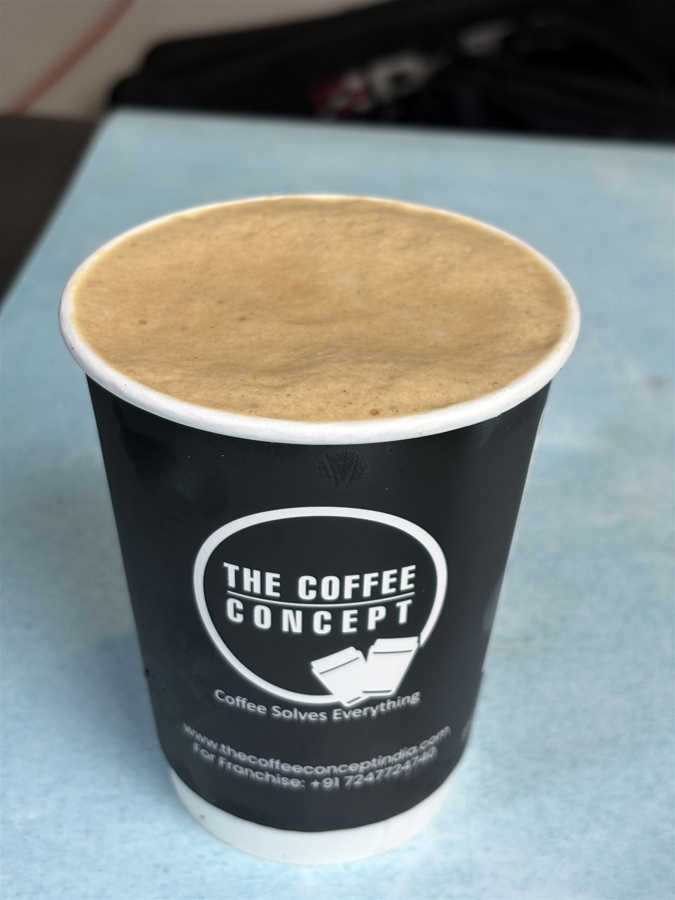 A hot coffee in a TCC cup