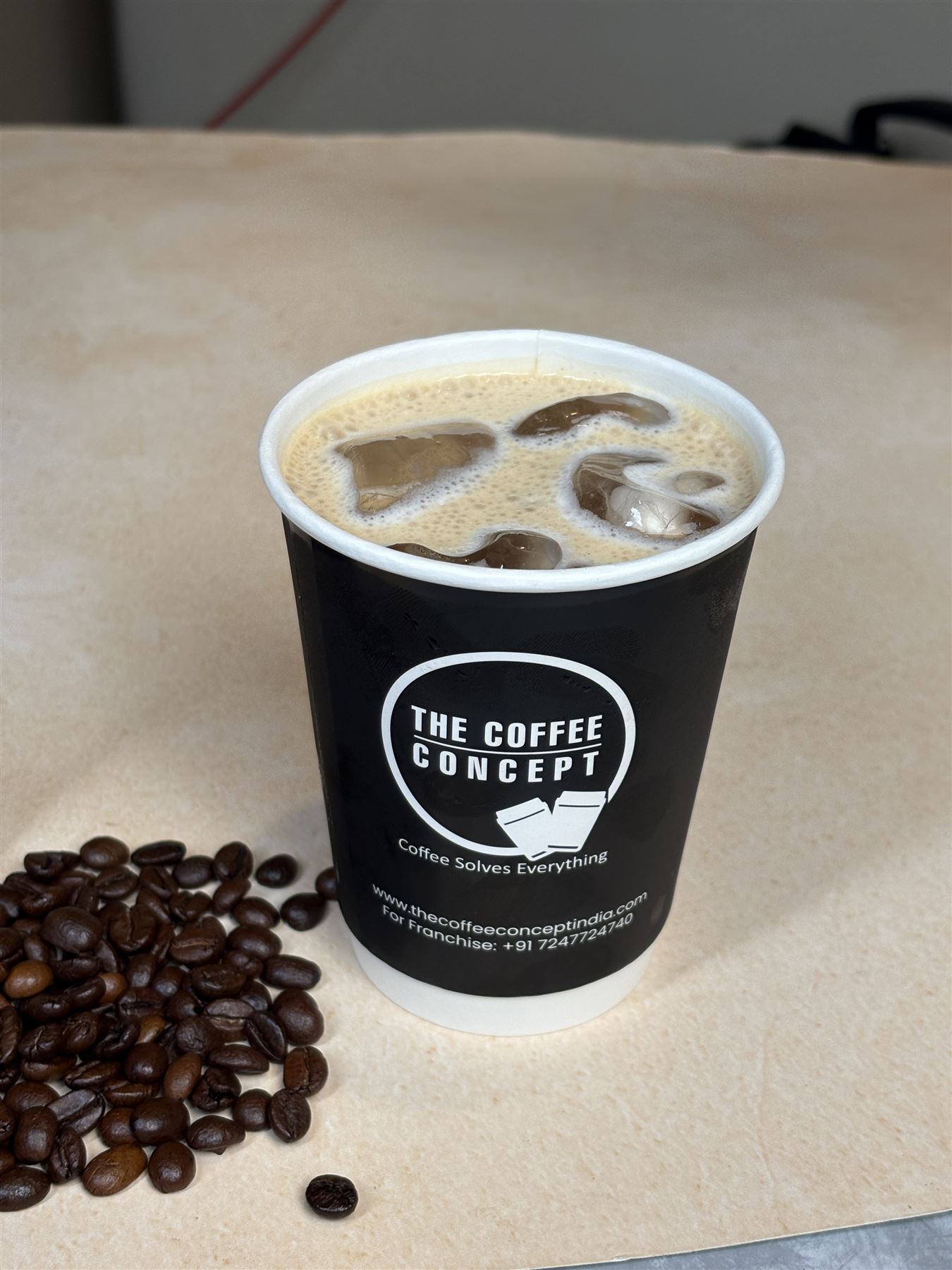 Takeaway iced latte in a TCC cup
