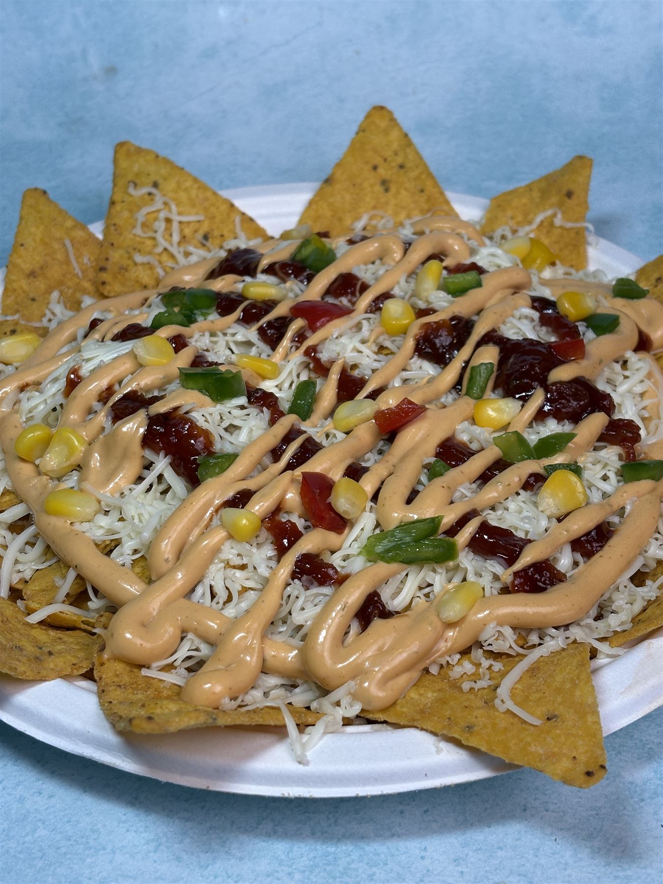 Loaded nachos with cheese, corn and peppers