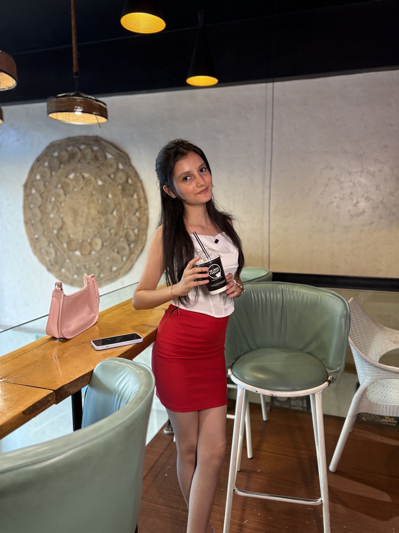 A guest with her coffee inside a TCC café