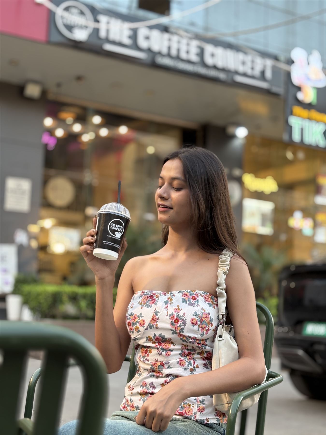 A guest with her drink outside the TCC storefront