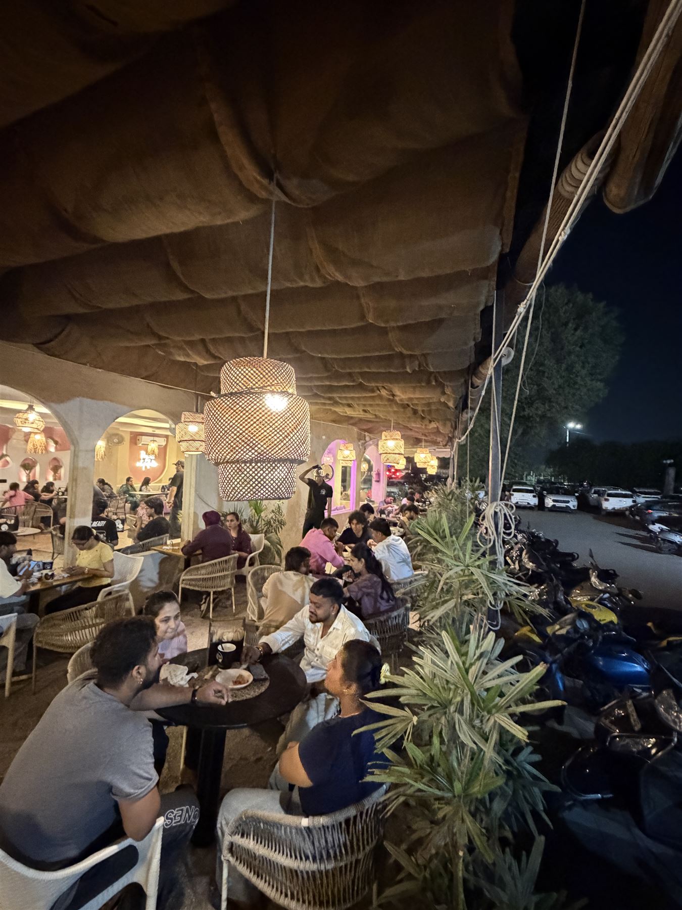 A full TCC café terrace at night